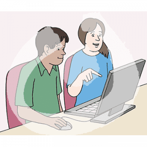 Zwei Personen sitzen vor einem Computer. Eine Person zeigt auf den Bildschirm.