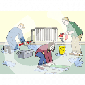 Drei Personen sind vor einer Heizung mit Pfützen davor. Eine Person in Blaumann hält eine Zange an ein Rohr. Die anderen beiden wischen das Wasser auf.