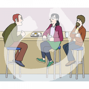 Drei Personen sitzen an einer Theke. Zwei Personen gucken eine Person an.