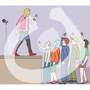 Eine Person steht auf einer Bühne mit einem Mikrofon. Sie guckt auf eine Schlange von fünf Personen mit erhobenen Händen.