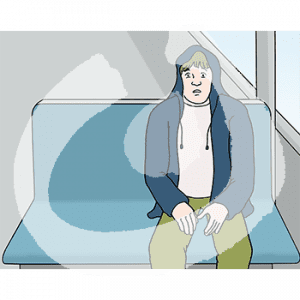 Eine ängstliche Person sitzt auf einer Bank in der Bahn.