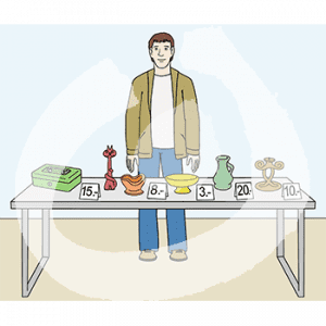 Eine Person steht hinter einem Tisch mit verschiedenen Gegenständen und Preisschildern.