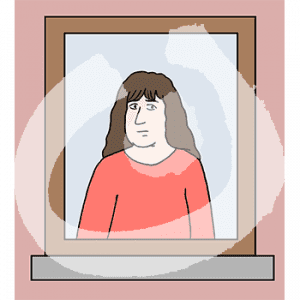 Eine Frau steht in einem Fenster.