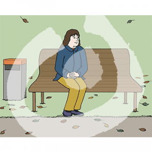 Eine Frau sitzt auf einer Bank im Park.