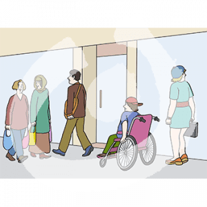 Drei Personen laufen an einem Laden vorbei. Eine Person guckt ins Schaufenster, daneben fährt eine Person im Rollstuhl.