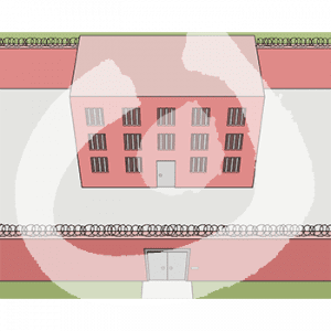 Vogelperspektive auf ein Gebäude mit vergitterten Fenstern und einen Hof mit Mauer und Stacheldraht.