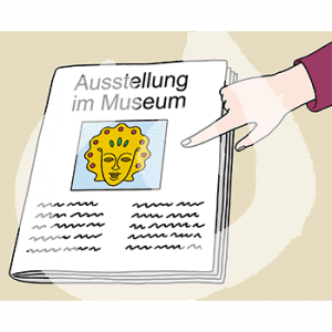Ein Finger zeigt auf eine Zeitung mit der Überschrift: Ausstellung im Museum. Darunter ist das Bild einer goldenen Maske.