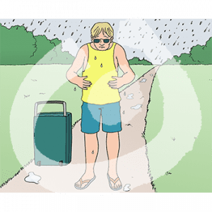 Ein Mann mit Koffer steht auf einem Weg im Grünen im Regen.