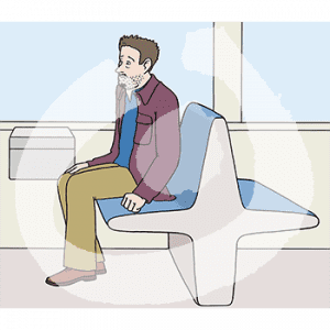 Ein trauriger Mann sitzt auf einer Bank im Zug.