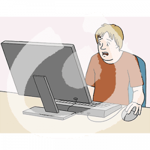 Eine verzweifelte Person sitzt an einem Tisch vor einem Computer. Sie guckt auf den Bildschirm.