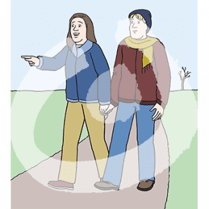 Ein Mann und eine Frau laufen Hand in Hand auf einem Weg im Grünen.