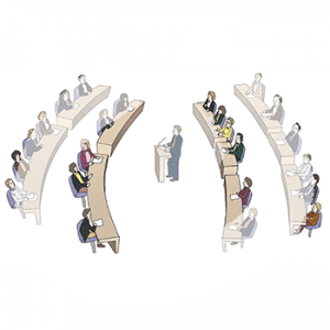 Eine Gruppe von Menschen sitzt an Parlamentsbänken. In der Mitte steht eine Person an einem Rednerpult. Dahinter sitzen weitere Personen an Parlamentsbänken.