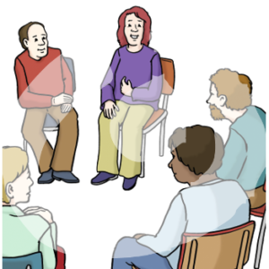 Fünf Personen sitzen in einem Stuhlkreis und gucke eine Person an. Diese Person zeigt auf sich.