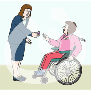 Eine Person reicht einer Person vor sich einen kleinen Gegenstand.