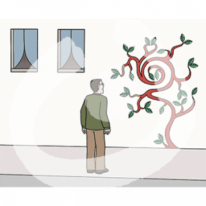 Eine Person steht vor einem Bild an einer Hauswand.