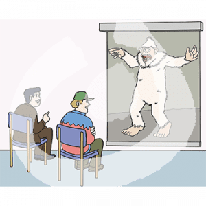 Zwei Personen sitzen vor einer Leinwand mit dem Bild eines schreienden Yetis.