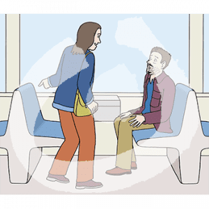 Eine erstaunte Person sitzt auf einer Bank in der Bahn. Sie guckt zu einer Person die auf den Platz gegenüber zeigt.