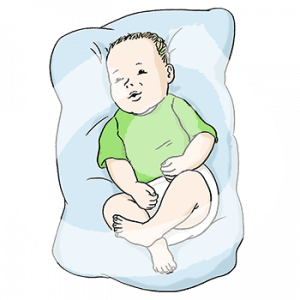 Ein Baby liegt auf einem Kissen.