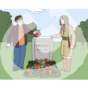 Zwei Personen stehen neben einem Grab. Eine Person legt einen Stapel Karten auf den Stein.