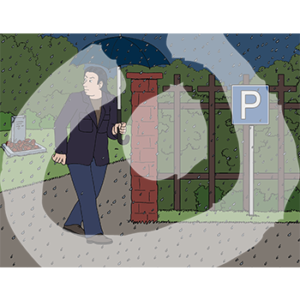 Eine Person läuft mit einem Regenschirm im Regen auf einen Parkplatz.