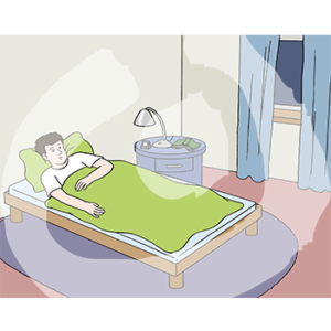 Eine Person liegt in einem Bett.