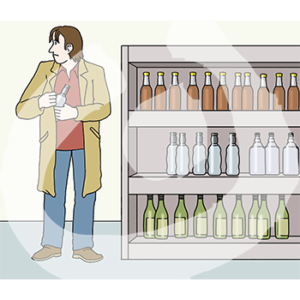 Eine Person steht neben einem Regal mit Flaschen und steckt eine Flasche unter ihre Jacke. Sie guckt zur Seite.