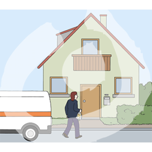 Eine Person geht auf ein Haus zu.