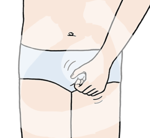 Eine Hand kratzt an einem mit einer Unterhose bedeckten Intimbereich.